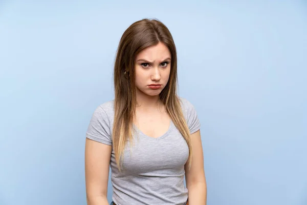 Adolescente Chica Sobre Aislado Azul Pared Con Triste Deprimido Expresión —  Fotos de Stock