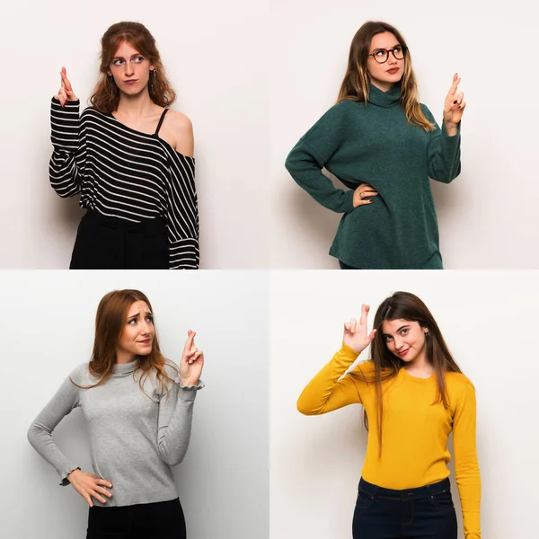 Set of women over white background with fingers crossing and wishing the best