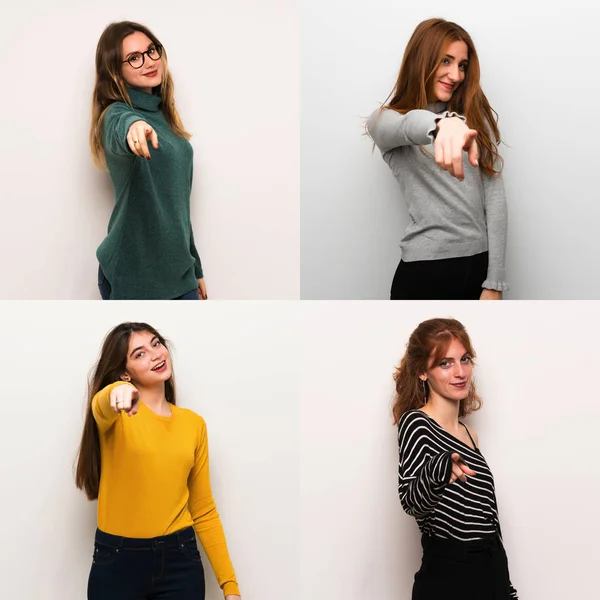 Set of women over white background points finger at you with a confident expression