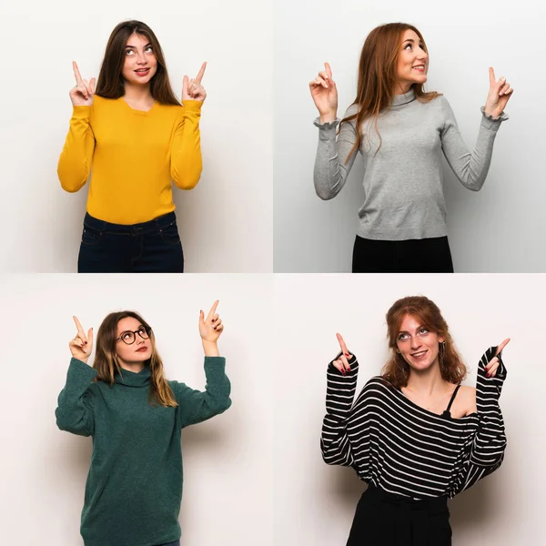 Set of women over white background pointing with the index finger a great idea
