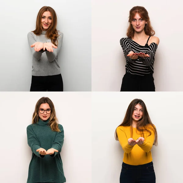 Set of women over white background holding copyspace imaginary on the palm to insert an ad