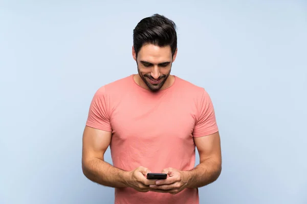 Handsome Young Man Pink Shirt Isolated Blue Background Sending Message — Stock Photo, Image