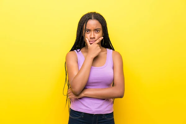 African American Teenager Girl Long Braided Hair Isolated Yellow Wall — Stock Photo, Image