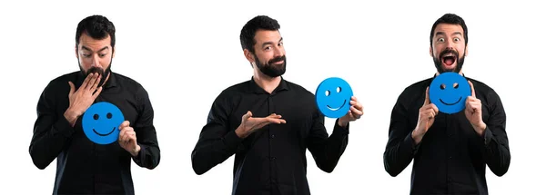 Conjunto de hombre guapo con barba sosteniendo un icono de la cara feliz — Foto de Stock