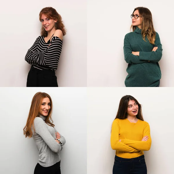 Set of women over white background keeping the arms crossed while smiling