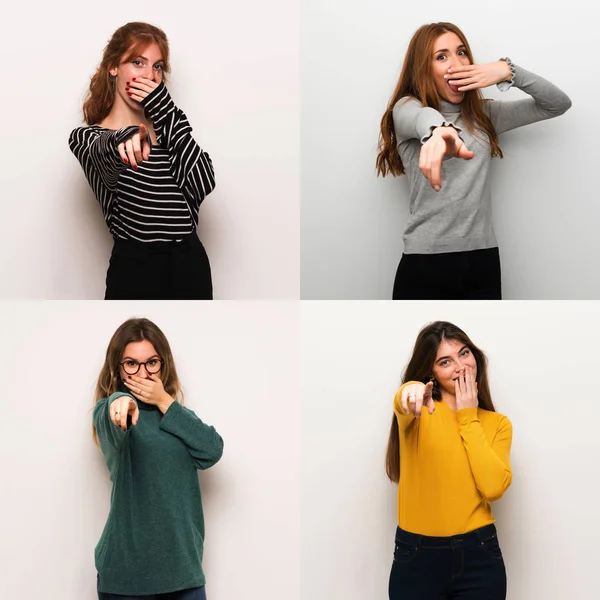 Set of women over white background pointing with finger at someone and laughing