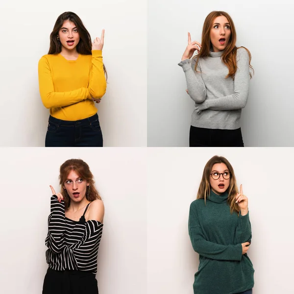 Set of women over white background thinking an idea pointing the finger up