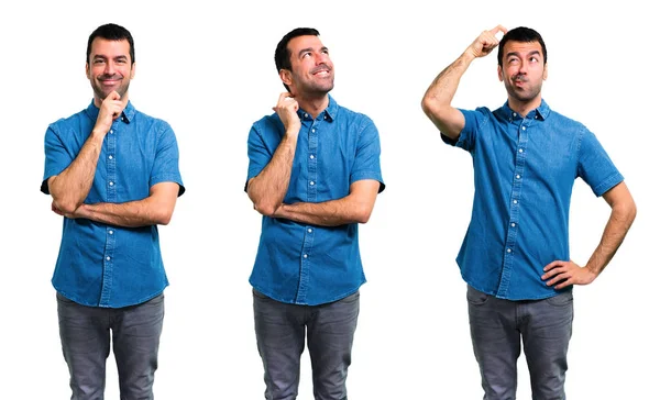 Set di bell'uomo con camicia blu in piedi e pensando un ide — Foto Stock