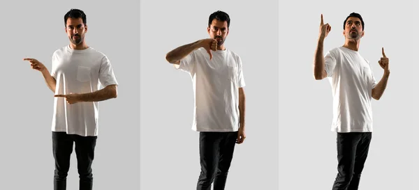 Sada mladého muže s bílou košilí, ukazující stranou nahoru a dolů po g — Stock fotografie