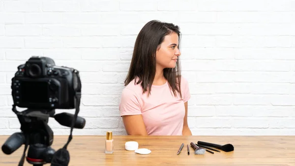 Young girl recording a video tutorial looking to the side