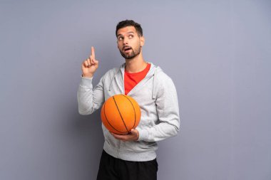 Yakışıklı genç basketbolcu adam bir parmak kaldırırken çözüm gerçekleştirmek niyetinde