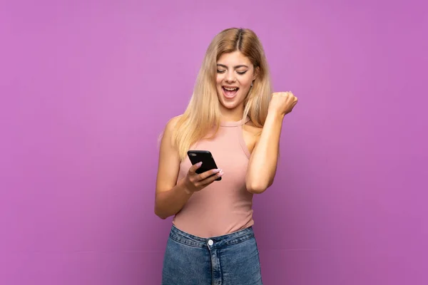 Teenager Girl Isolated Purple Background Phone Victory Position — Stock Photo, Image