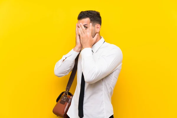 Handsome Businessman Isolated Yellow Background Covering Eyes Looking Fingers — Stock Photo, Image