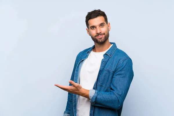 Hombre Guapo Sobre Fondo Azul Aislado Presentando Una Idea Mientras — Foto de Stock