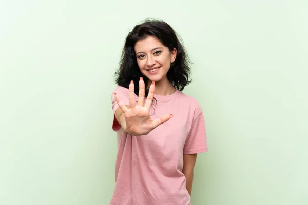 Νεαρή Γυναίκα Πάνω Από Απομονωμένο Πράσινο Φόντο Μετρώντας Πέντε Δάχτυλα — Φωτογραφία Αρχείου