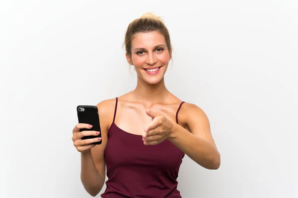 Young Blonde Woman Using Mobile Phone Handshaking Good Deal — Stock Photo, Image