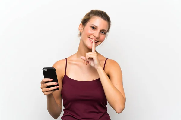 沈黙のジェスチャーを行う携帯電話を使用して若いブロンドの女性 — ストック写真