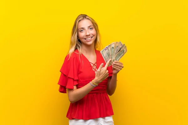 Blonde Young Woman Isolated Yellow Background Taking Lot Money — Stock Photo, Image