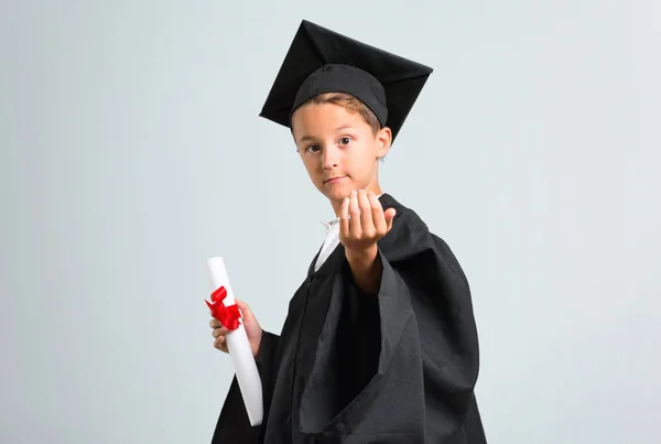 Little boy graduating presenting and inviting to come on grey background