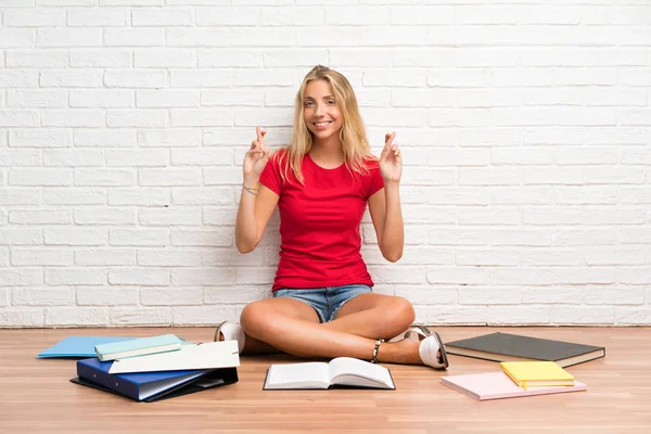 Young Blonde Student Girl Many Books Floor Fingers Crossing — Stock Photo, Image