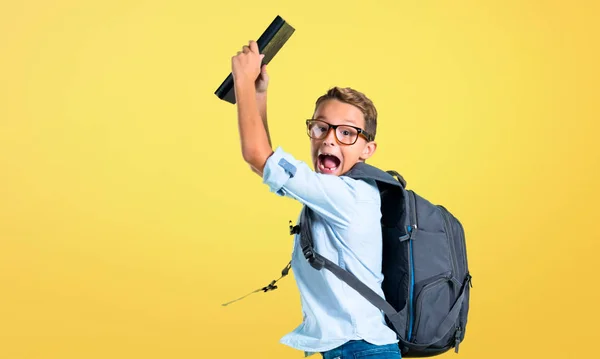 Student Kid Backpack Glasses Holding Book Jumping Yellow Background — Stock Photo, Image