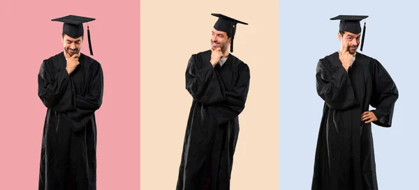一套人在他的毕业日大学站在看五颜六色的背景 — 图库照片