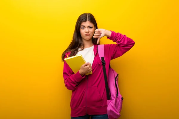 Nastolatek Uczeń Dziewczyna Żywe Żółte Tło Pokazując Kciuka Dół Znak — Zdjęcie stockowe