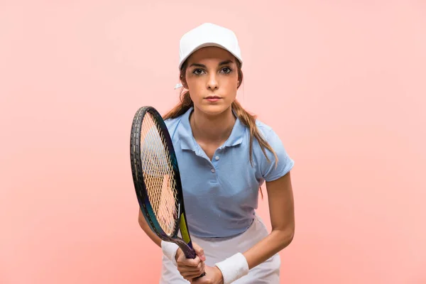 Young tennis player woman over isolated pink wall — Stock Photo, Image