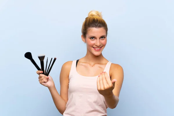 Young Blonde Woman Holding Lots Makeup Brush Inviting Come Hand Stock Photo