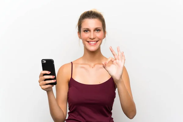 Young Blonde Woman Using Mobile Phone Showing Sign Fingers — Stock Photo, Image