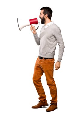 Yakışıklı adam izole beyaz arka plan üzerinde bir megafon ile bağırarak