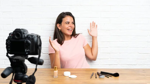 Young girl recording a video tutorial with surprise facial expression