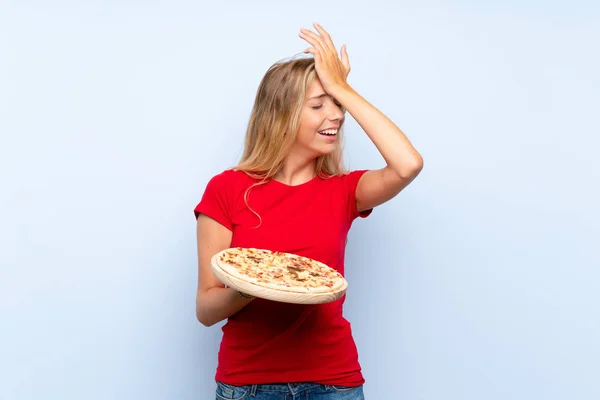 Joven Mujer Rubia Sosteniendo Una Pizza Sobre Una Pared Azul — Foto de Stock