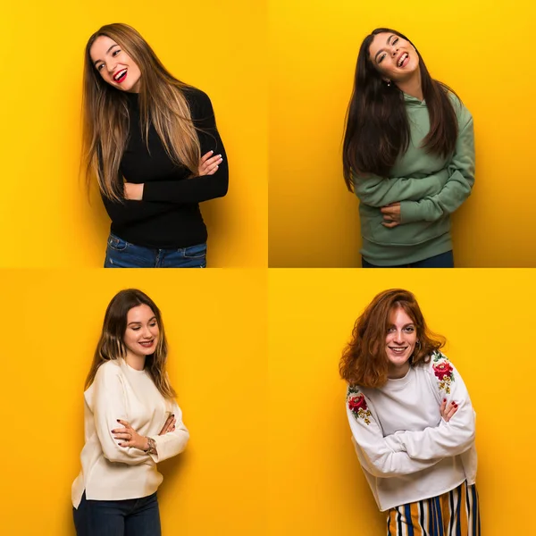 Conjunto Mujeres Sobre Fondo Amarillo Manteniendo Los Brazos Cruzados Mientras —  Fotos de Stock