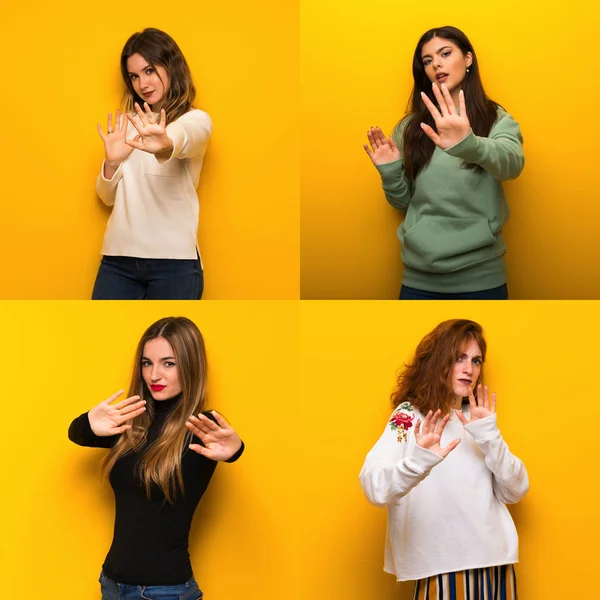 Sarı Arka Plan Üzerinde Kadın Seti Biraz Gergin Elleri Germe — Stok fotoğraf