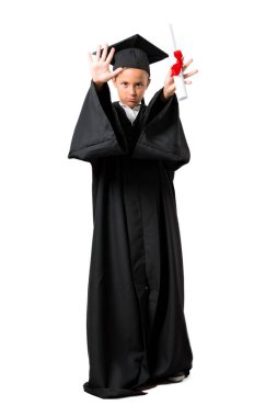 Izole beyaz arka plan üzerinde eliyle stop jest yapma küçük çocuk mezun tam vücut