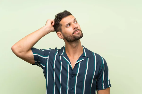 Hombre Guapo Sobre Fondo Aislado Que Tiene Dudas Con Expresión — Foto de Stock