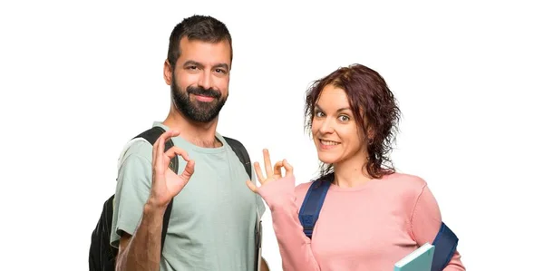 Zwei Studenten Mit Rucksäcken Und Büchern Die Ein Zeichen Mit — Stockfoto