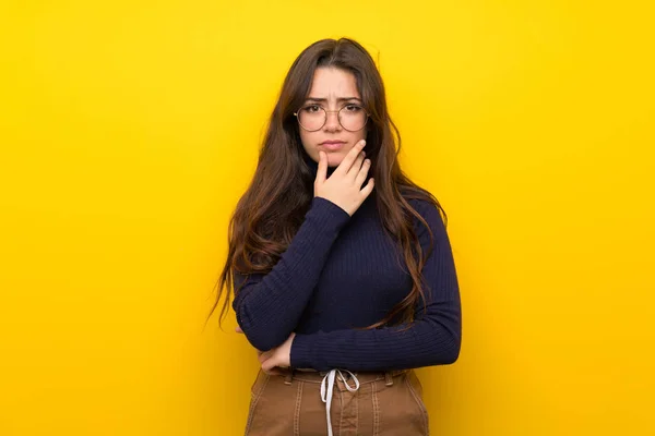 Adolescente Menina Sobre Isolado Parede Amarela Pensando — Fotografia de Stock