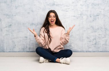 Genç öğrenci kız şok yüz ifadesi ile bir masada okuyan