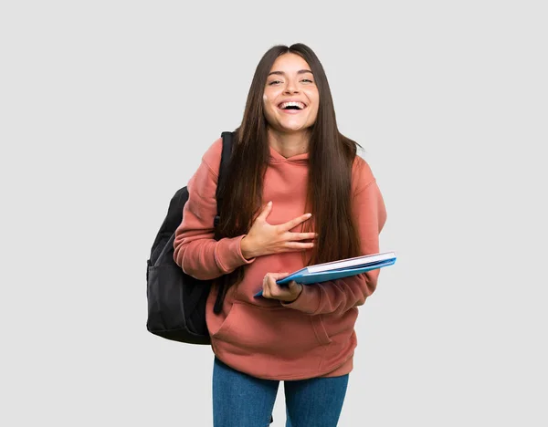 Joven Estudiante Sosteniendo Cuadernos Sonriendo Mucho Sobre Fondo Gris Aislado —  Fotos de Stock