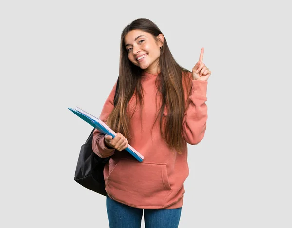 Joven Estudiante Sosteniendo Cuadernos Mostrando Levantando Dedo Señal Del Mejor —  Fotos de Stock