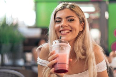 Kız bir çilek smoothie içme
