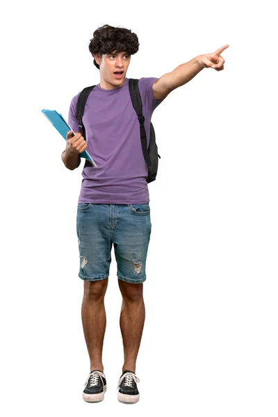 一个年轻学生男子指着孤立的白色背景的全长镜头 — 图库照片