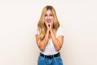 Sürpriz yüz ifadesi ile izole arka plan üzerinde genç sarışın kadın