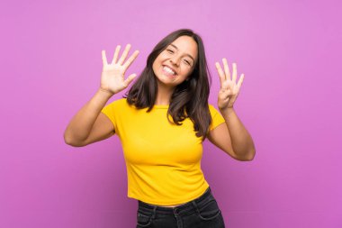 Izole arka plan üzerinde genç esmer kız parmakları ile dokuz sayma