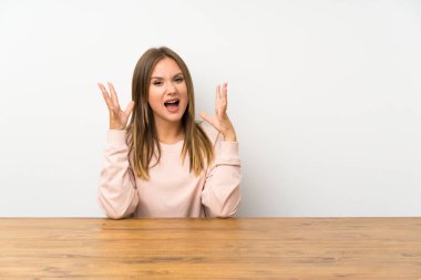 Bir masada genç kız mutsuz ve bir şey ile sinirli