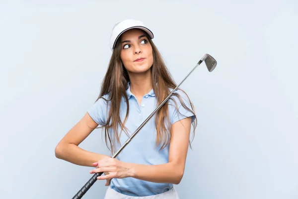 Young Golfer Woman Isolated Blue Wall Looking While Smiling — Stock Photo, Image