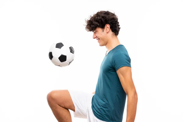 Молодой футболист за изолированной белой стеной — стоковое фото