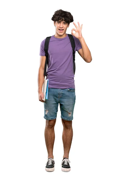 孤立した白い背景の上にOkサインと親指アップジェスチャーを示す若い学生の男のフルレングスショット — ストック写真